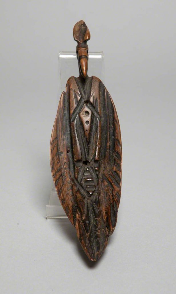 Brown woodcarving of a Perched Bird with Folded Wings