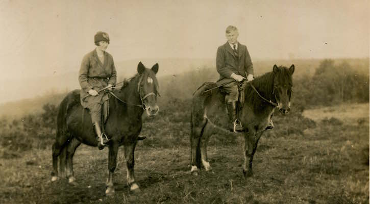Margaret and Tom Charman on horseback in a field